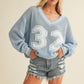 VARSITY V-NECK SWEATER TOP