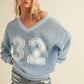 VARSITY V-NECK SWEATER TOP